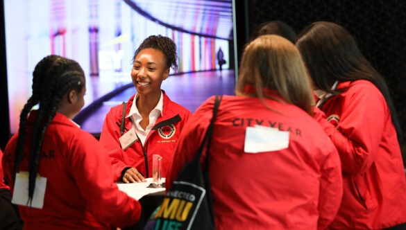 Group of volunteer mentors in red jackets