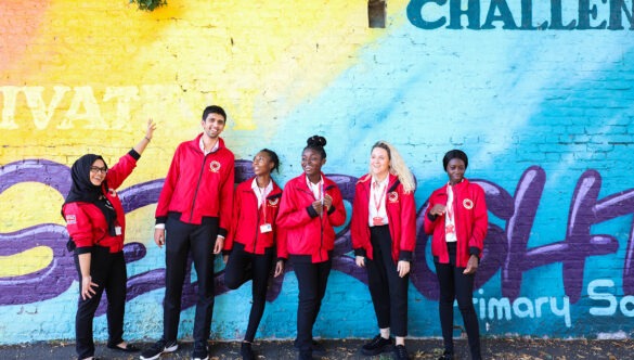 Volunteer mentors against a graffiti wall