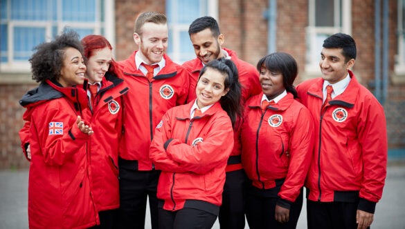 Group of volunteer mentors in red jackets