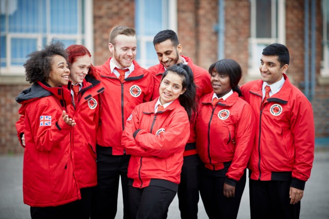 Group of volunteer mentors in red jackets