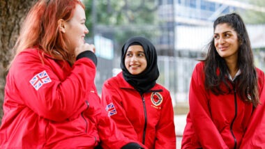 Three volunteer mentors looking at each other