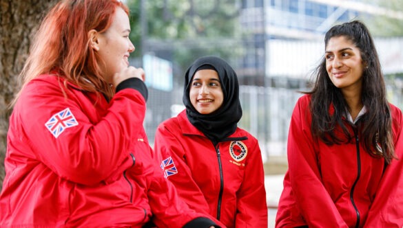 Three volunteer mentors looking at each other