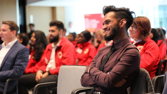 Audience members sitting and smiling