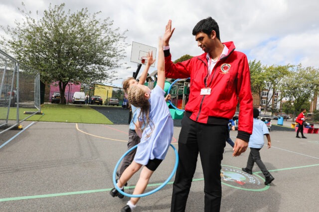 volunteer with pupils on school playground