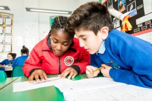 Volunteer mentor working with a pupil