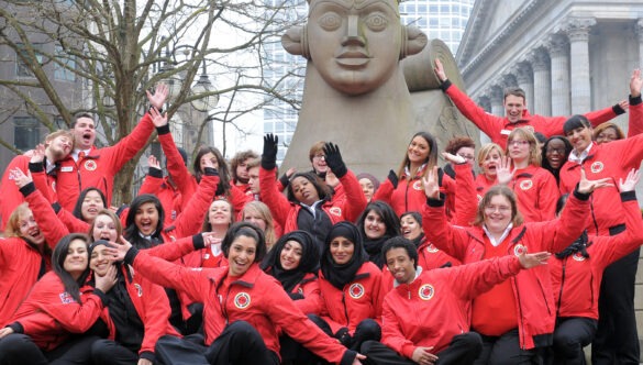 Birmingham volunteer mentors in front of a statue