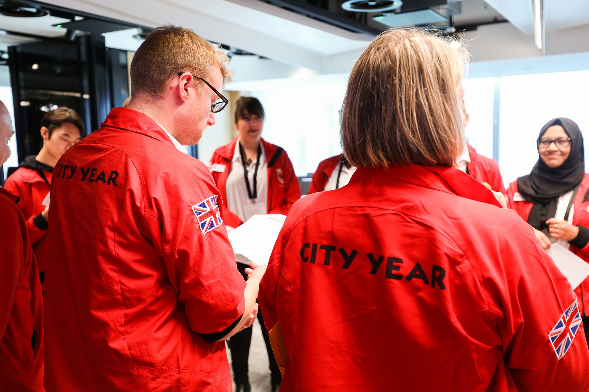 backs of red jackets 